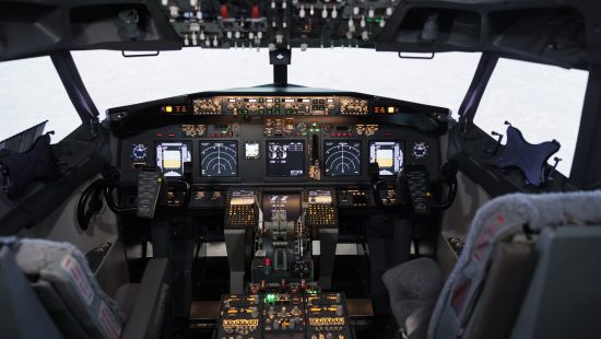 Empty airplane cockpit with electronic flying navigation panel Empty airplane cockpit with electronic flying navigation panel, control command with buttons and lever on dashboard. No people in aircraft cabin to throttle engine and takeoff.